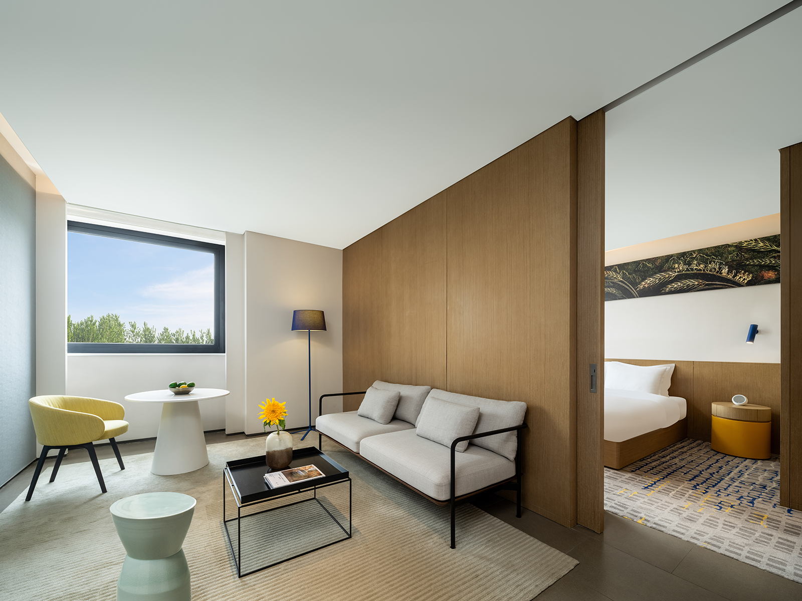 14hotel suite living room with wood wall panel Hotel interior design ideas guest room