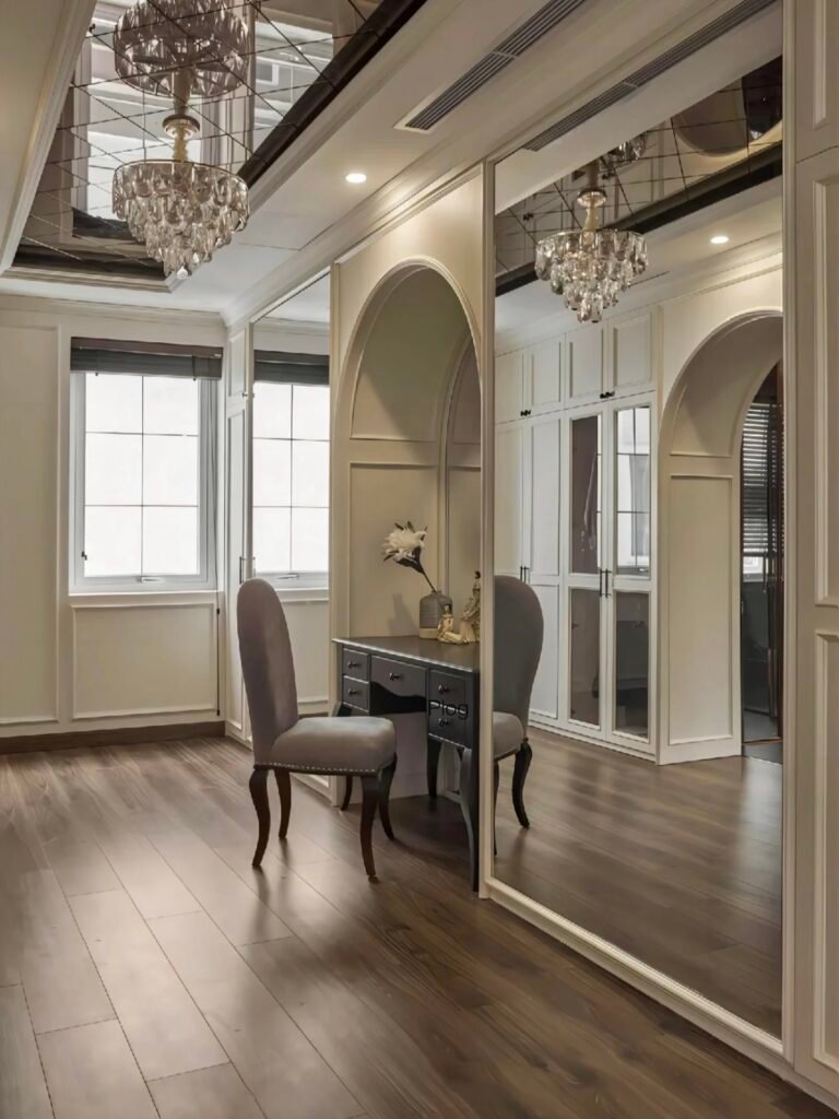 cream style walk in closet with mirror panels