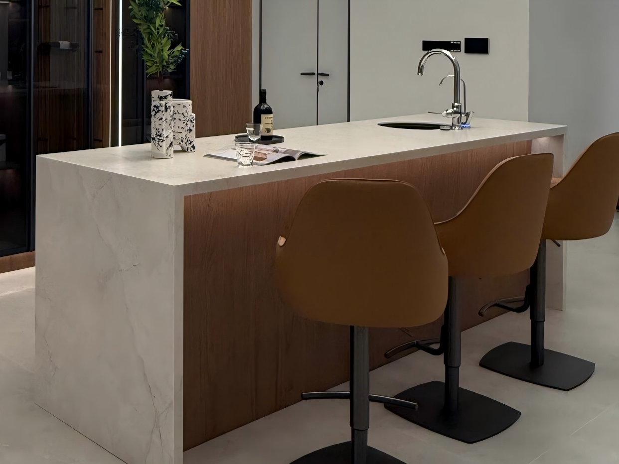 marble-waterfall-kitchen-island-with-wood-cabinets