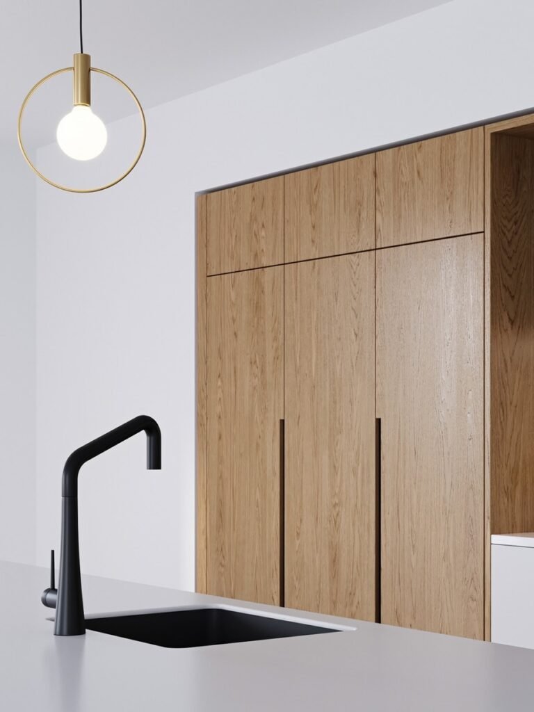 matte black faucet and wood kitchen cabinet detail