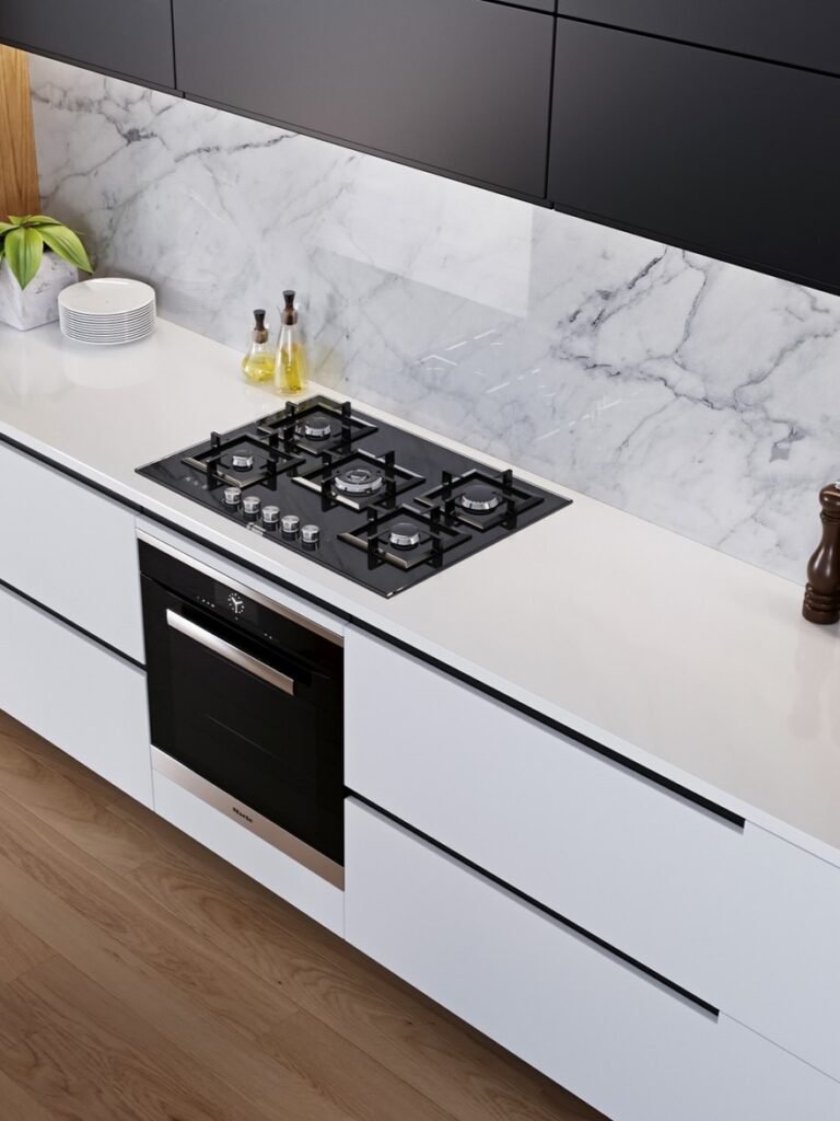 modern kitchen cooktop and marble backsplash detail