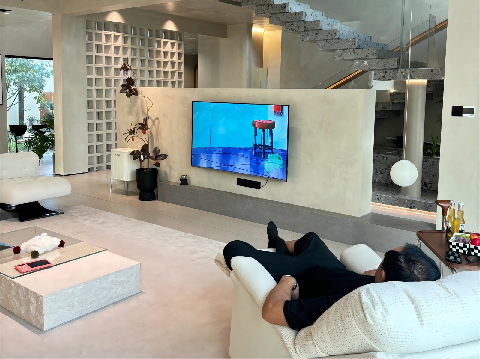 modern villa living room with tv wall and floating staircase modern-villa-living-room-with-tv-wall-and-floating-staircase