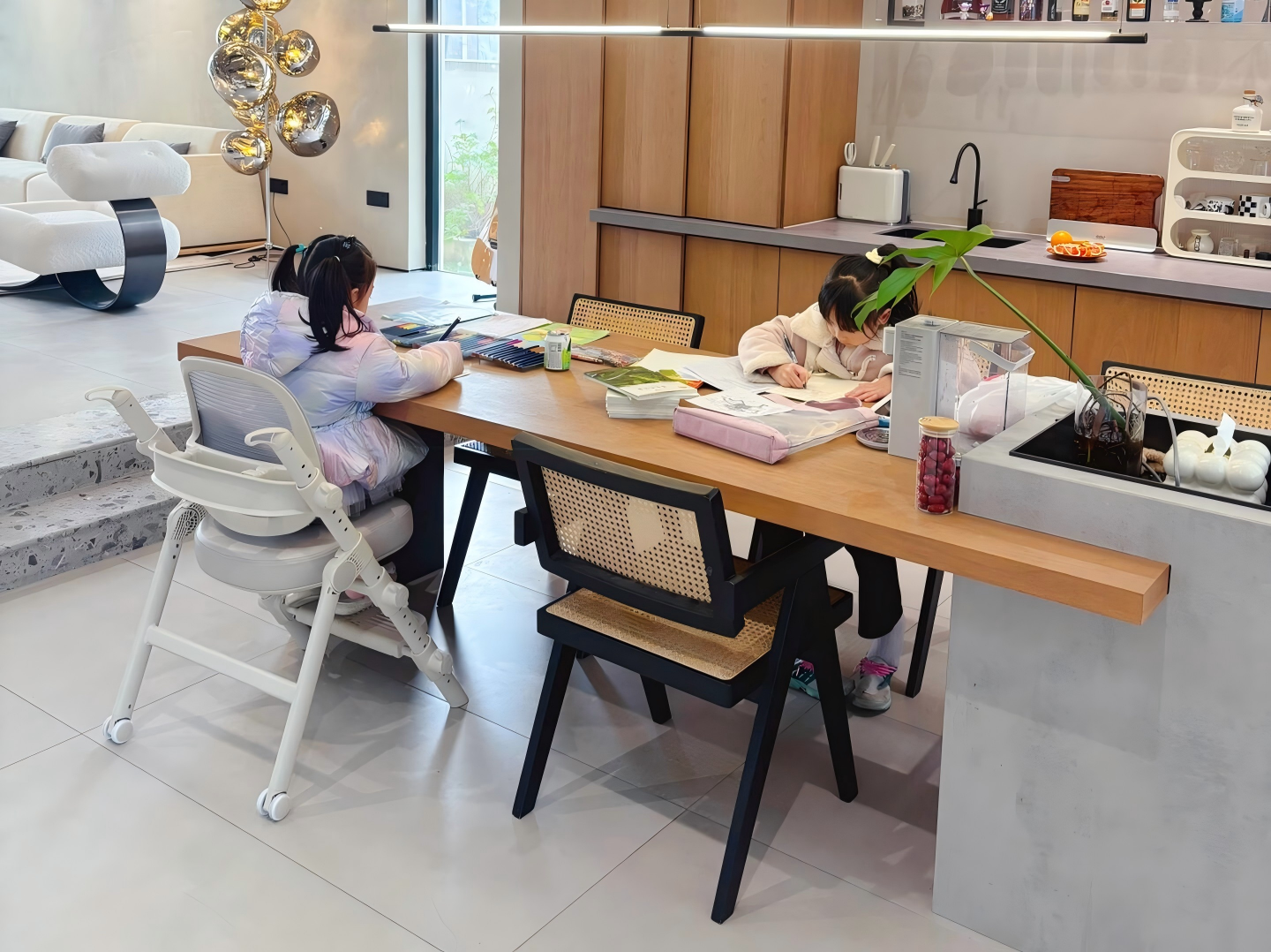 open plan villa kitchen with wood cabinets and study table open-plan-villa-kitchen-with-wood-cabinets-and-study-table