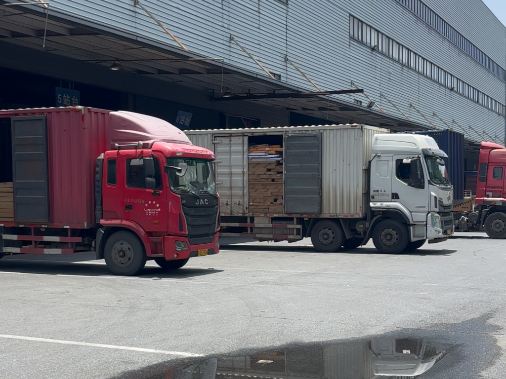 Container trucks loading custom furniture products for international export and global delivery