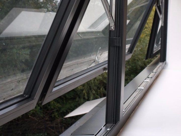 Awning window scissor arm hardware close-up