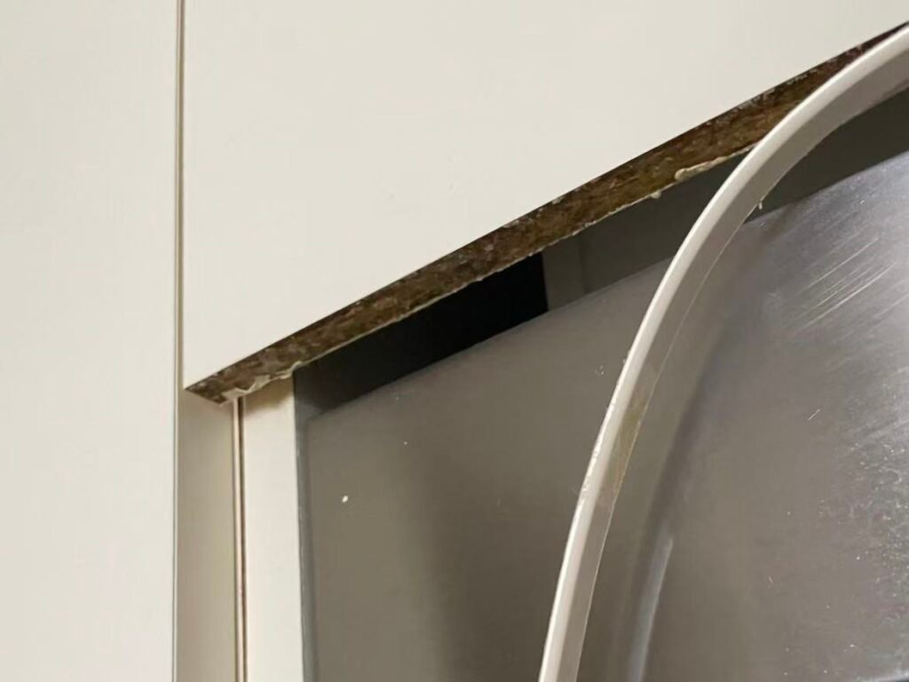 Peeling laminate cabinet edge near sink