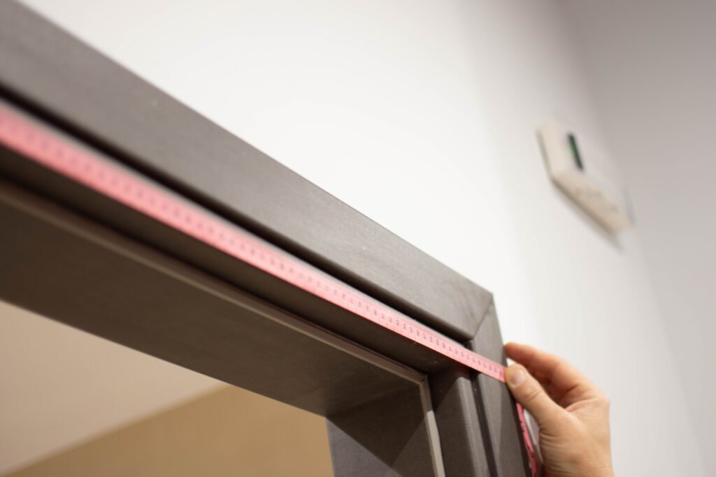 Tape measure checking door frame head jamb