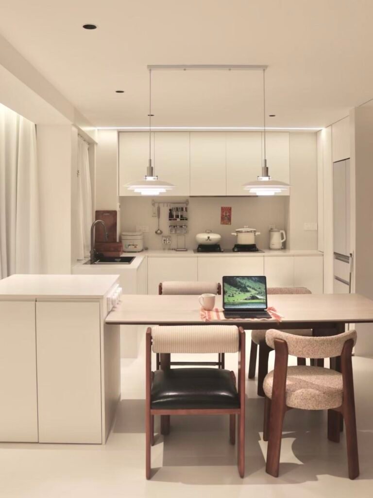 White modular galley kitchen with cove lighting