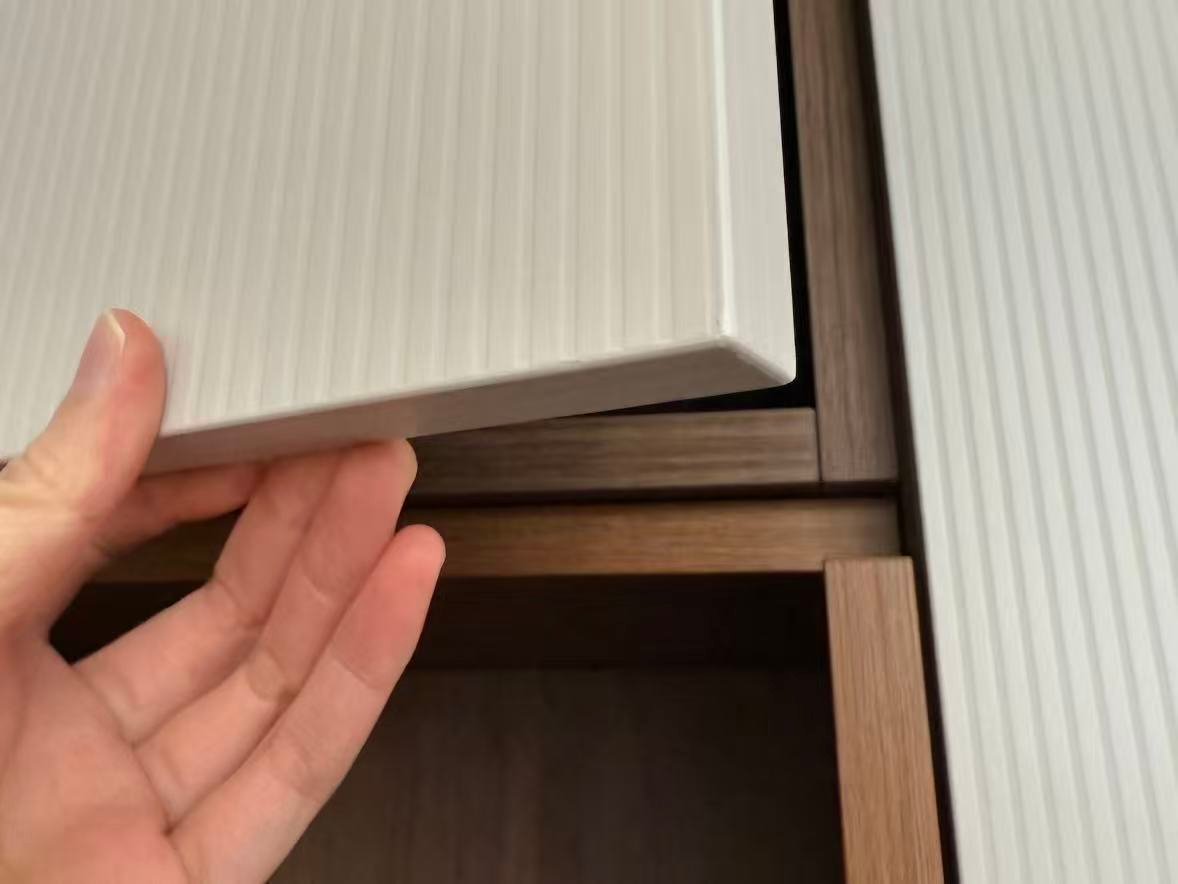 Checking cabinet edge quality in showroom