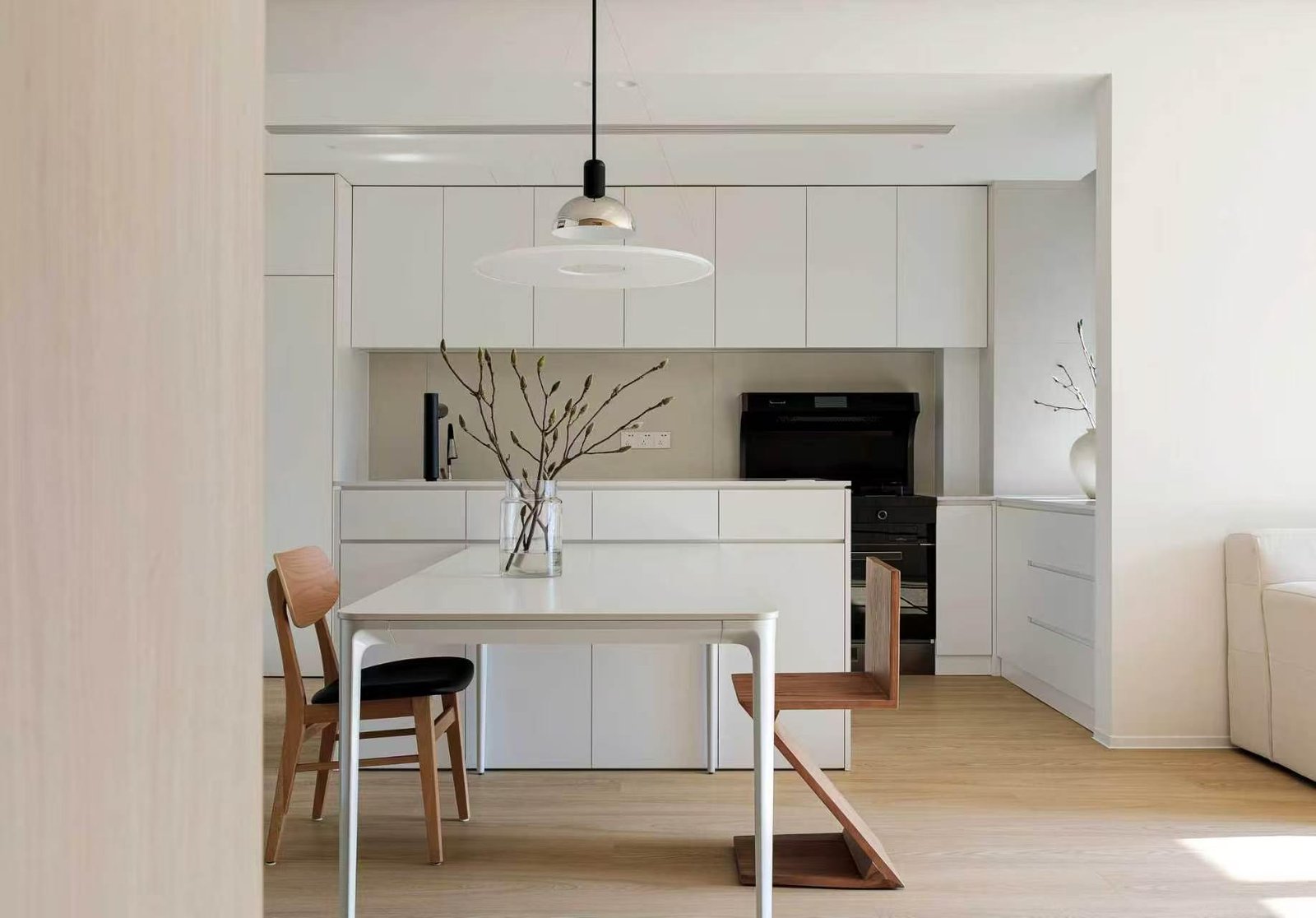 Compact apartment kitchen with custom white cabinets