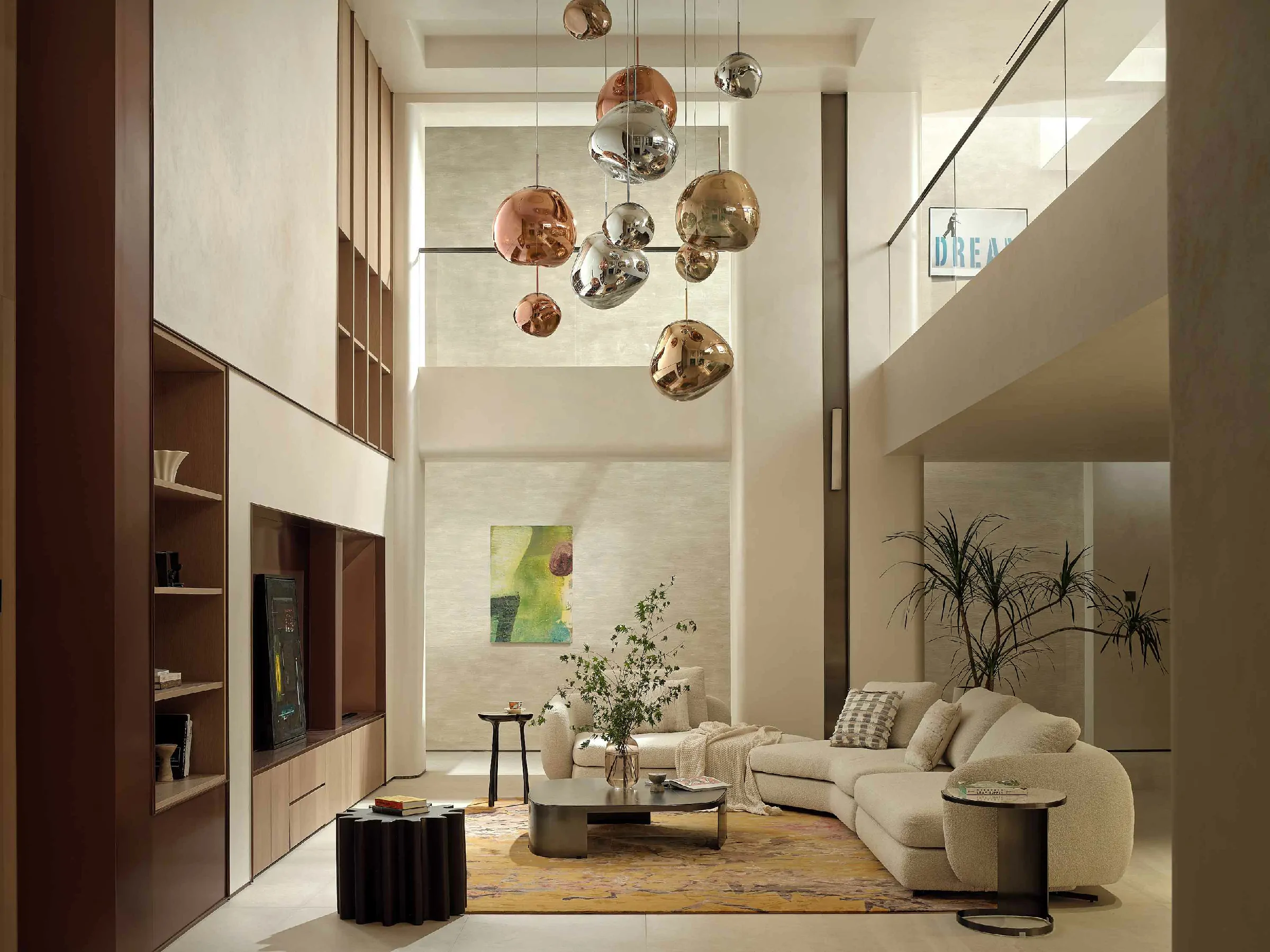 Double-height villa living room with built-in cabinetry