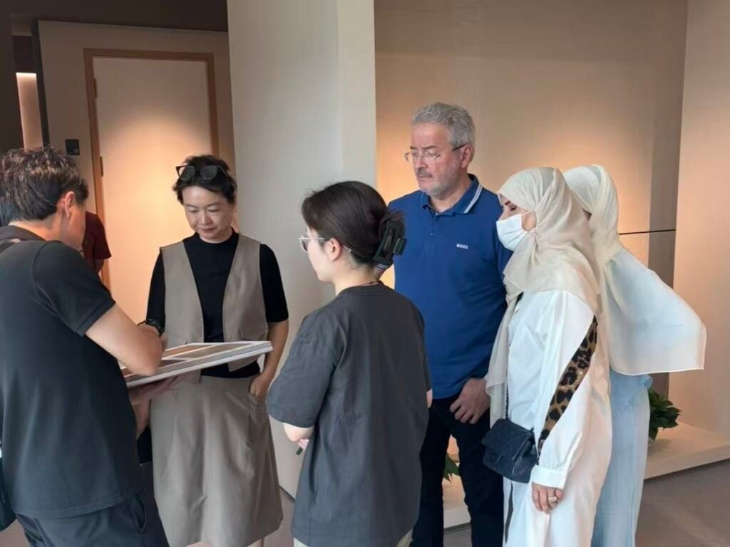 Clients reviewing cabinet materials with manufacturer team