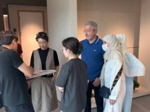kitchen cabinet manufacturer client material consultation.jpg Clients reviewing cabinet materials with manufacturer team
