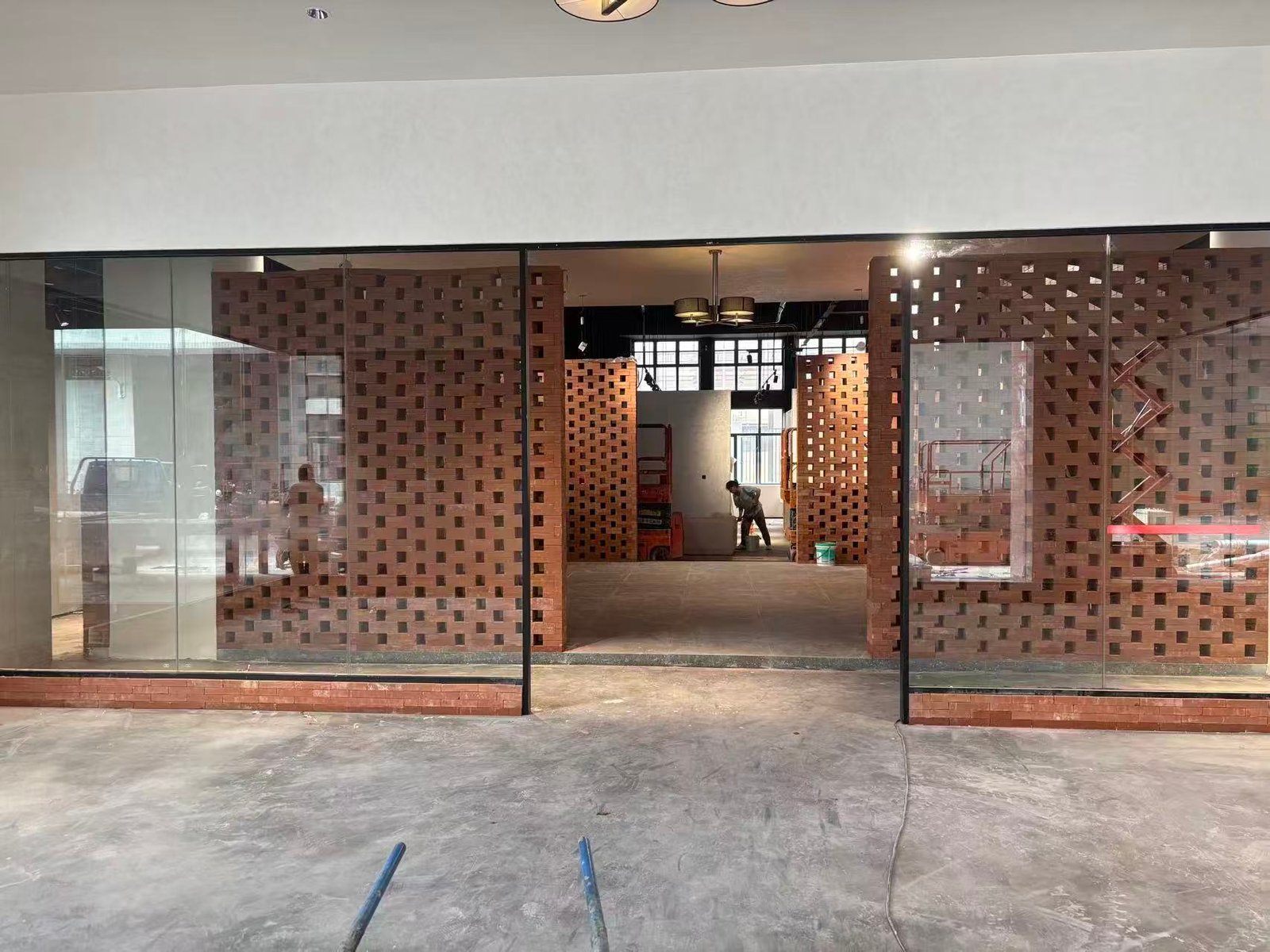 Hotel construction site showing custom interior door opening and glass partition installation