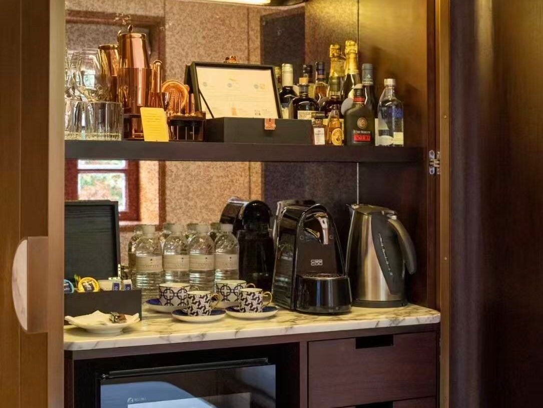 Hotel minibar cabinet with refrigerator drawers and stone countertop