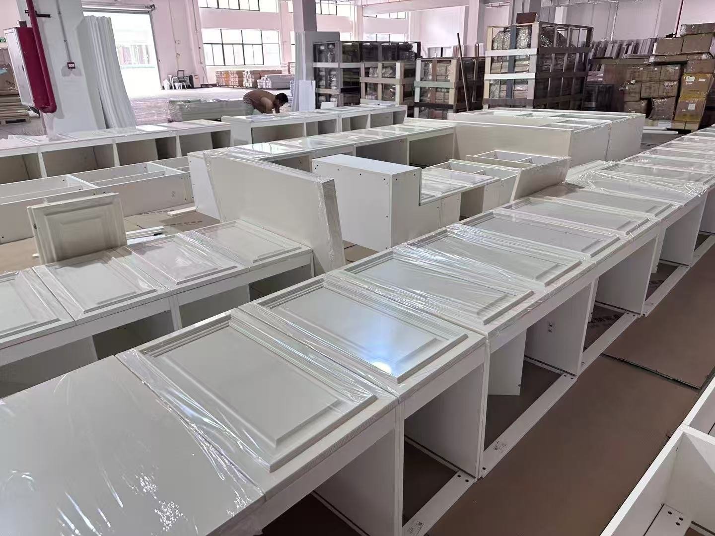 White Shaker cabinets arranged for batch inspection before packing
